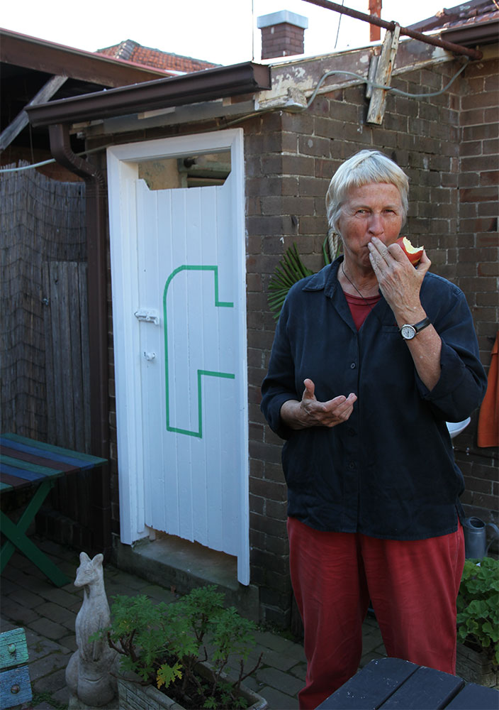 Margaret Roberts: Architectural Composition with Backyard, 2013, installation view with artist. Masking tape on wooden doors
