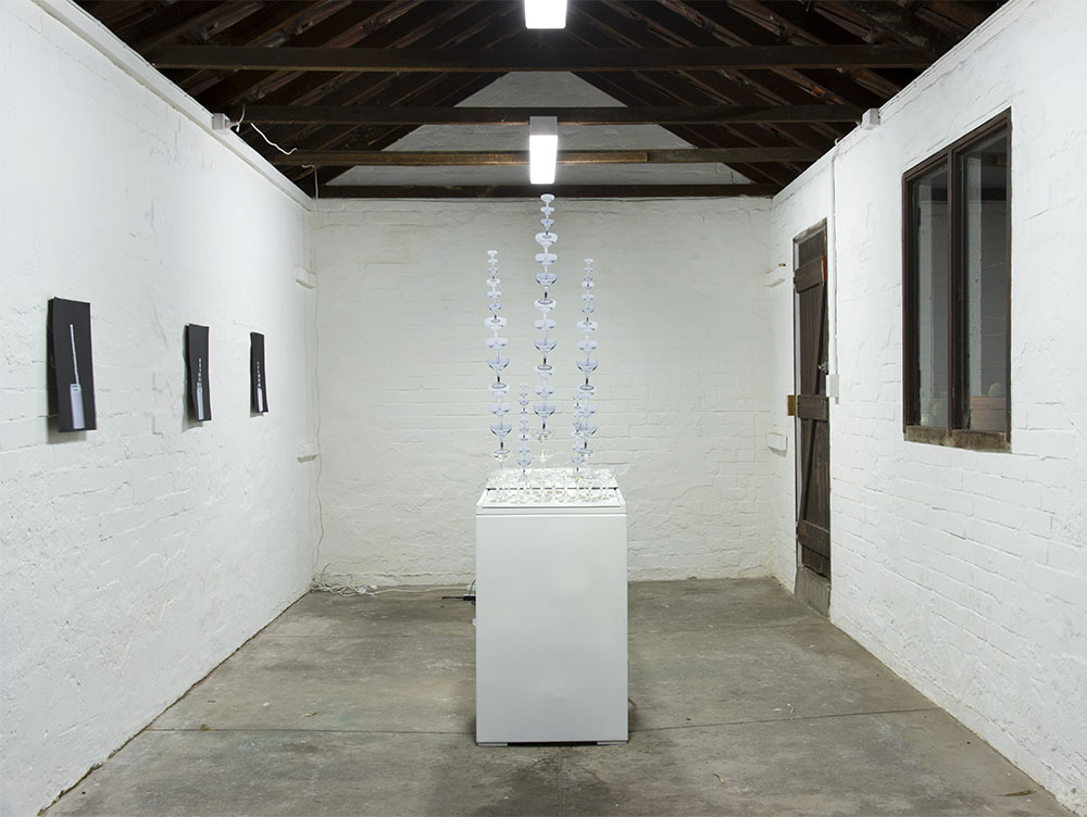 Josie Cavallaro: Spin, 2013. Washing machine, champagne glasses, sound, paper